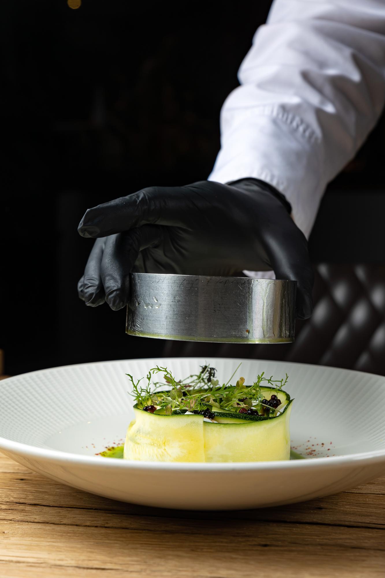 chef arranging garnish on plate